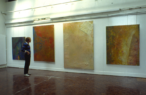 John McSweeney standing beside four large paintings in Camberwell School of Art, 1982